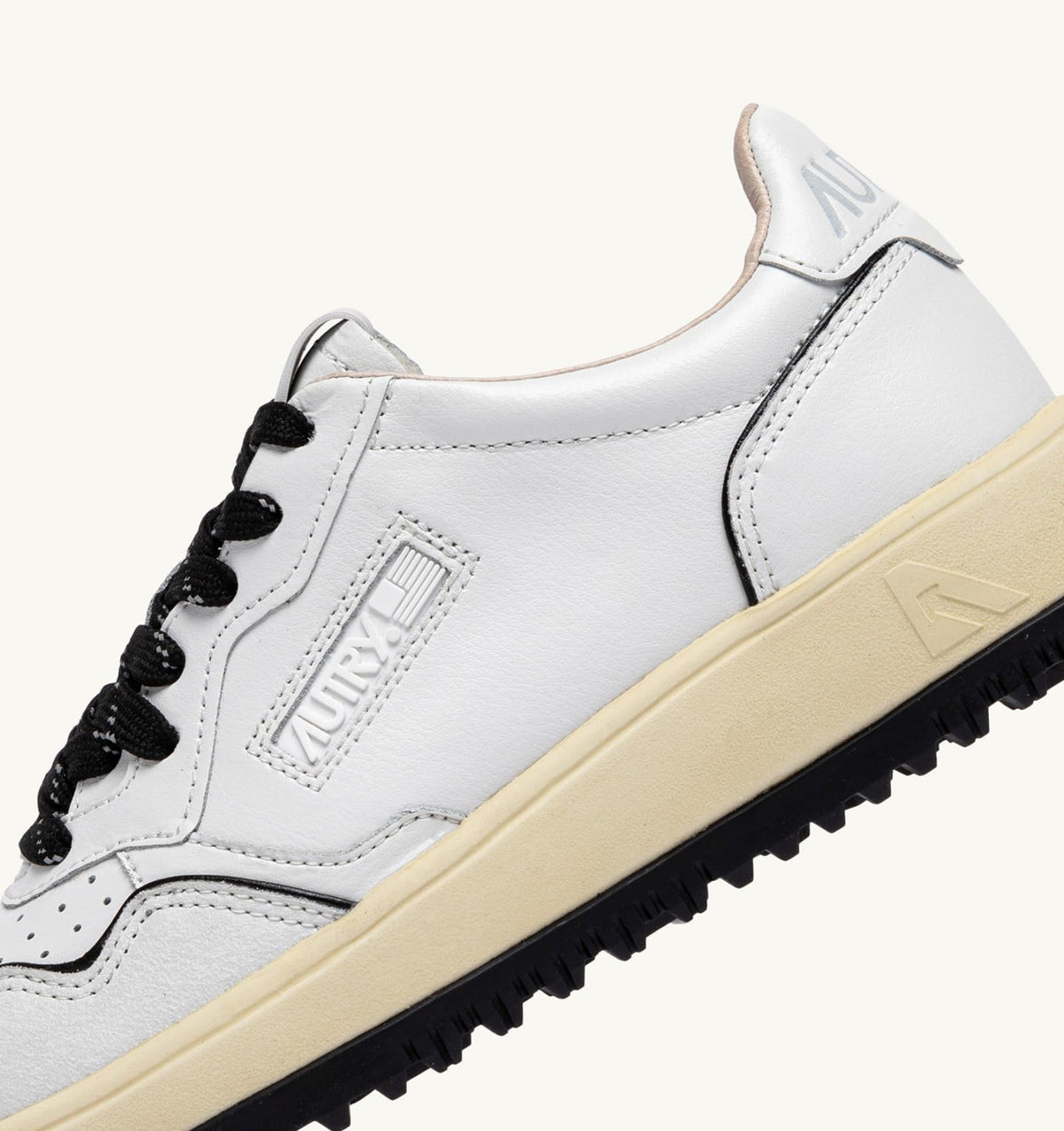 AUTRY GOLF LOW SNEAKERS IN WHITE AND BLACK LEATHER